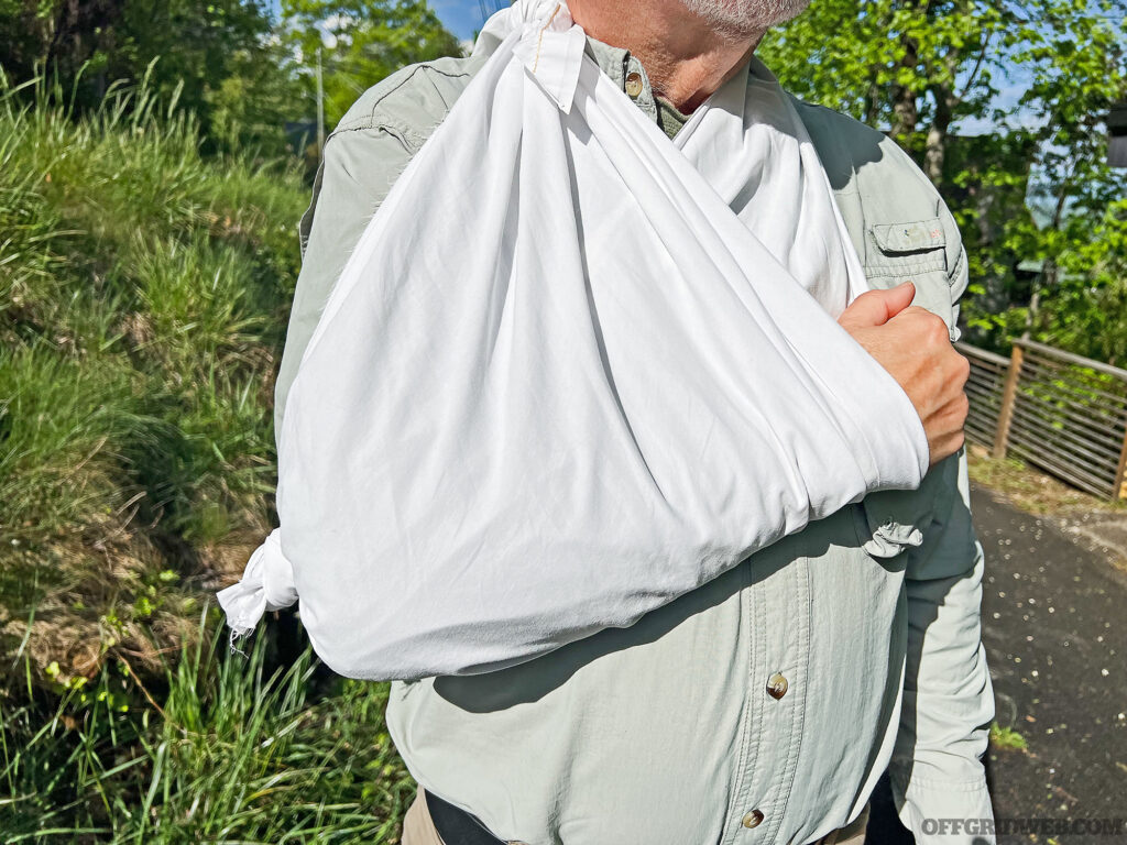 An arm being lifted in a triangular bandage sling.