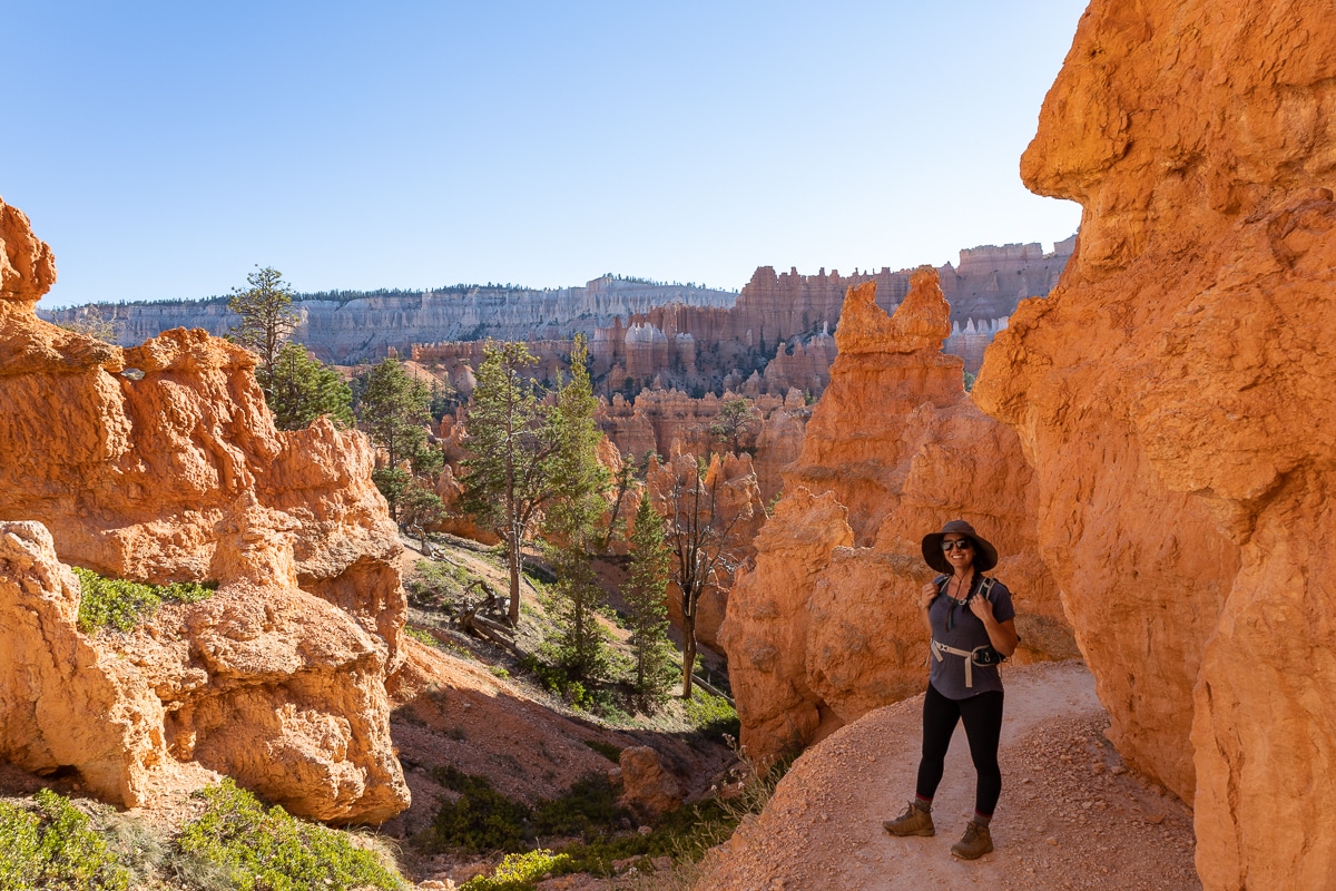 Woman posing for a photo on the Navajo Loop Trail in Bryce Canyon National Park.