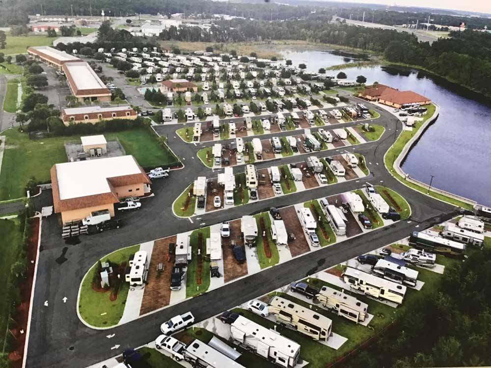 Aerial shot of RV park near river. 
