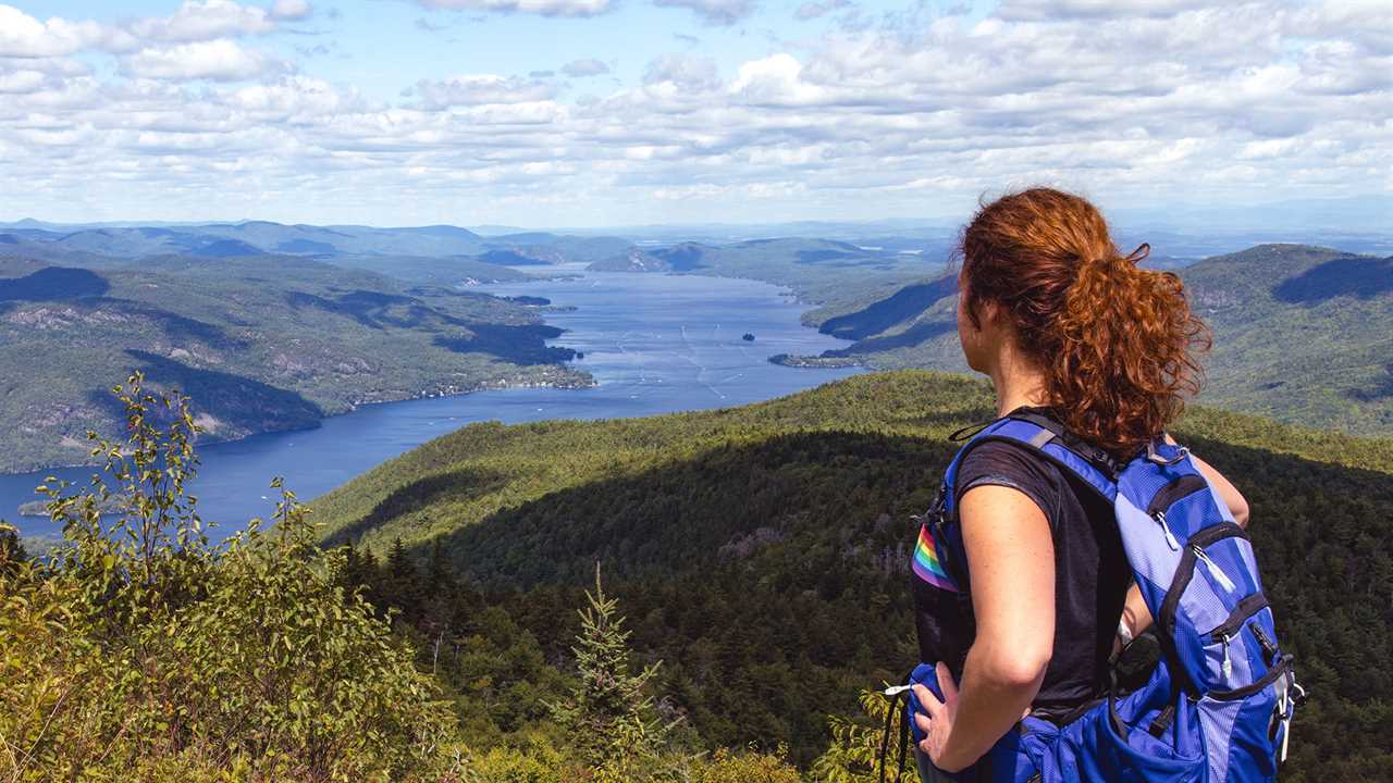 Woman overlooking long lake that stretches into the horizon.