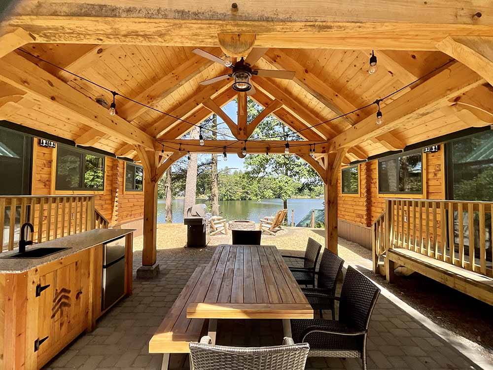 Wooden table under a-frame structure.