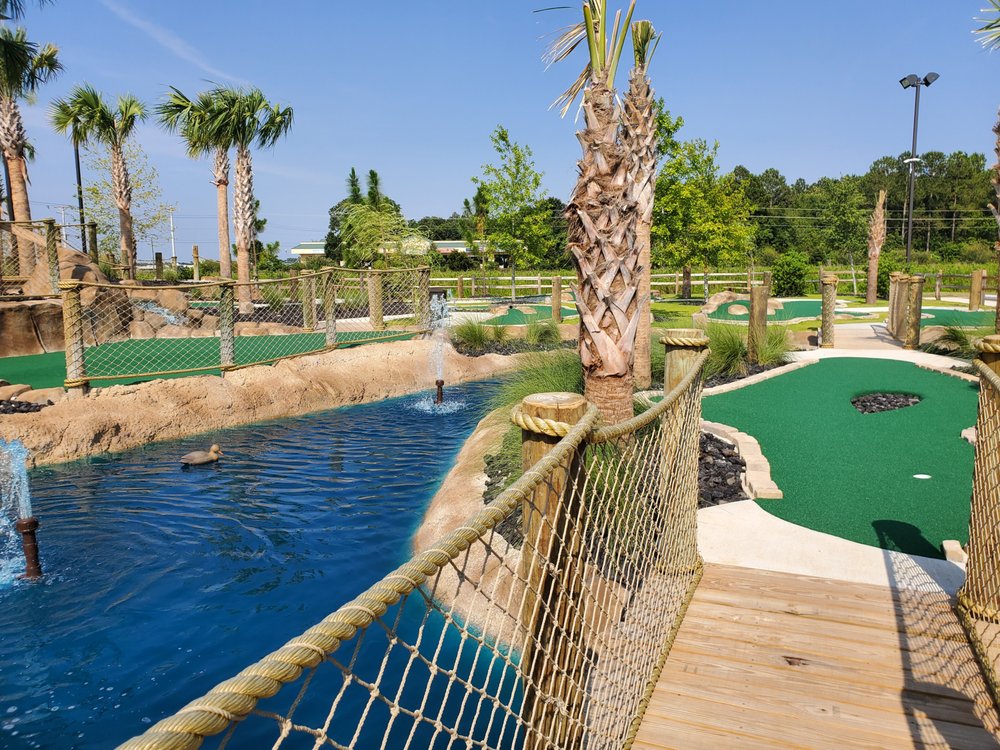 A mini golf course near a water feature.