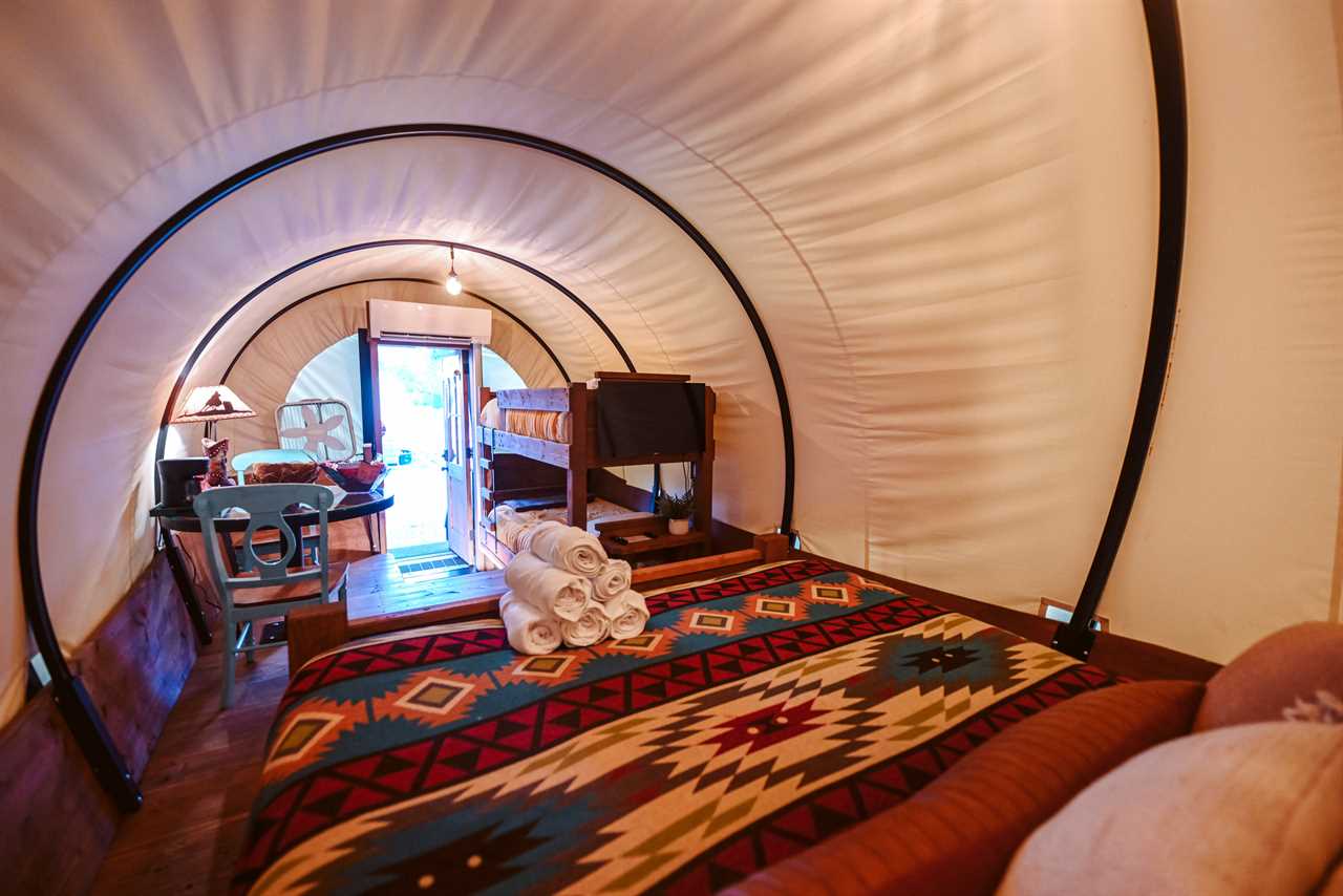 Interior of a Conestoga wagon with Navajo bedspread.