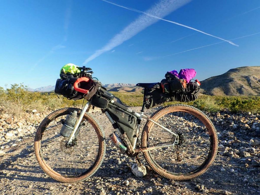 Salsa Fargo bike on a gravel road in the desert with a classic bikepacking bag setup