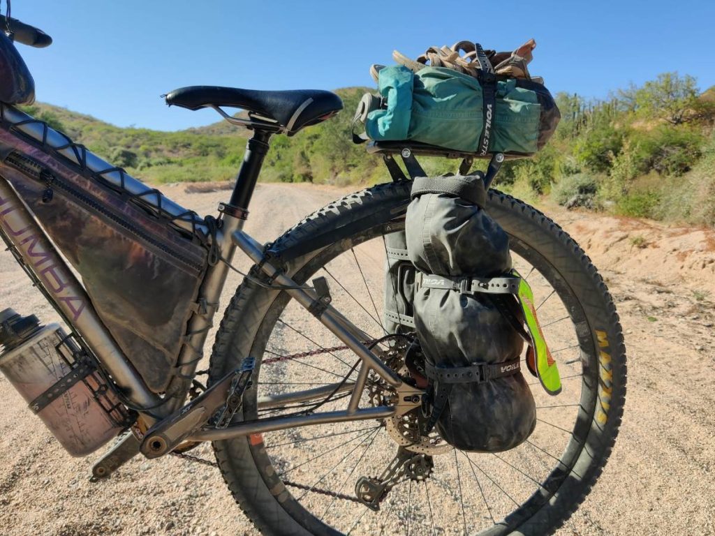 Closeup of Elkhorn rack with black dry bags on the sides and blue dry bag strapped to the deck