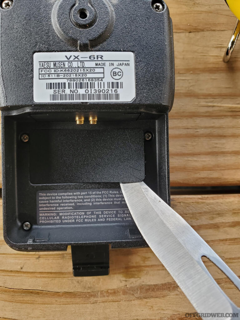 Remove the battery and peel back the protective film in the battery compartment to expose the circuit board.