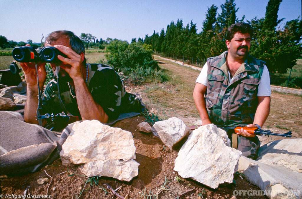 Two men standing guard at a checkpoint.