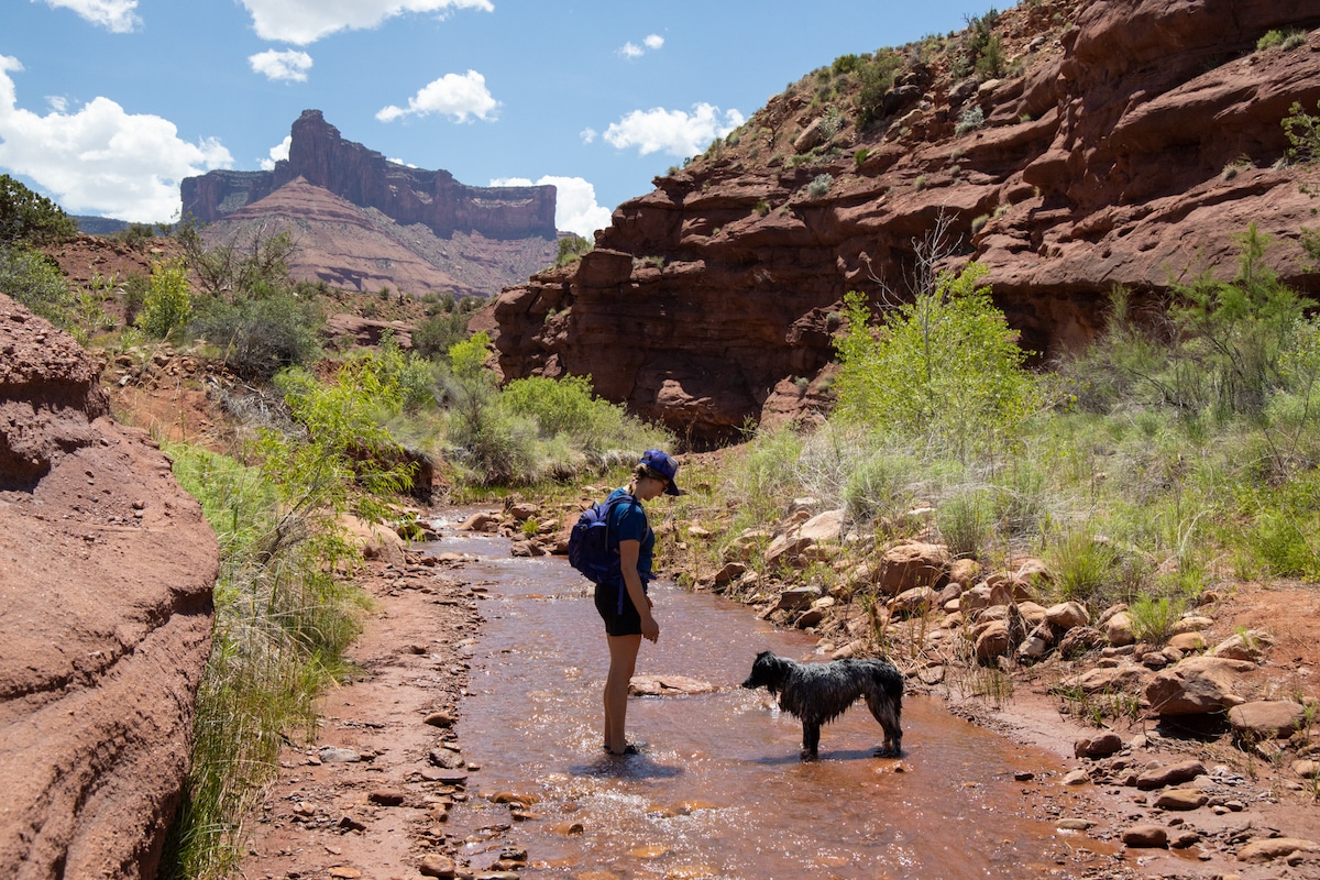 Bearfoot Theory founder Kristen Bor with a dog on the Mary Jane Falls hike in Moab