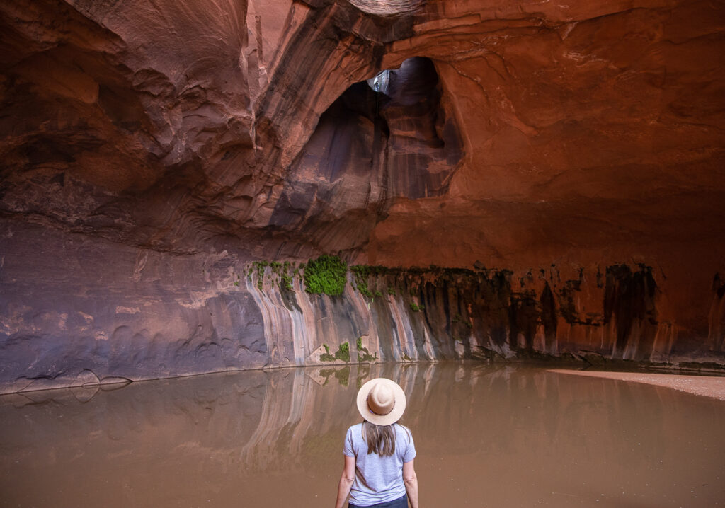 Bearfoot Theory founder Kristen Bor standing next to a pool of water in Neon Canyon in Escalante