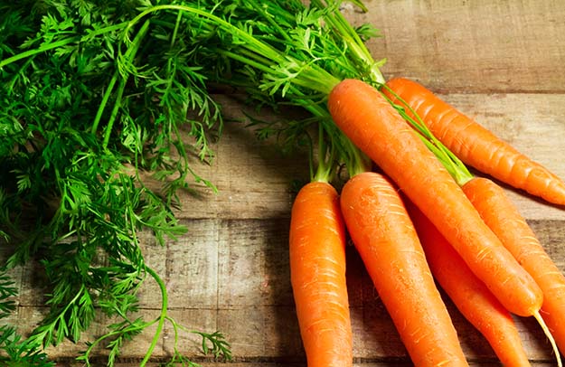 Carrots on wooden table | Grow Your Garden All Year Long With An Indoor Garden