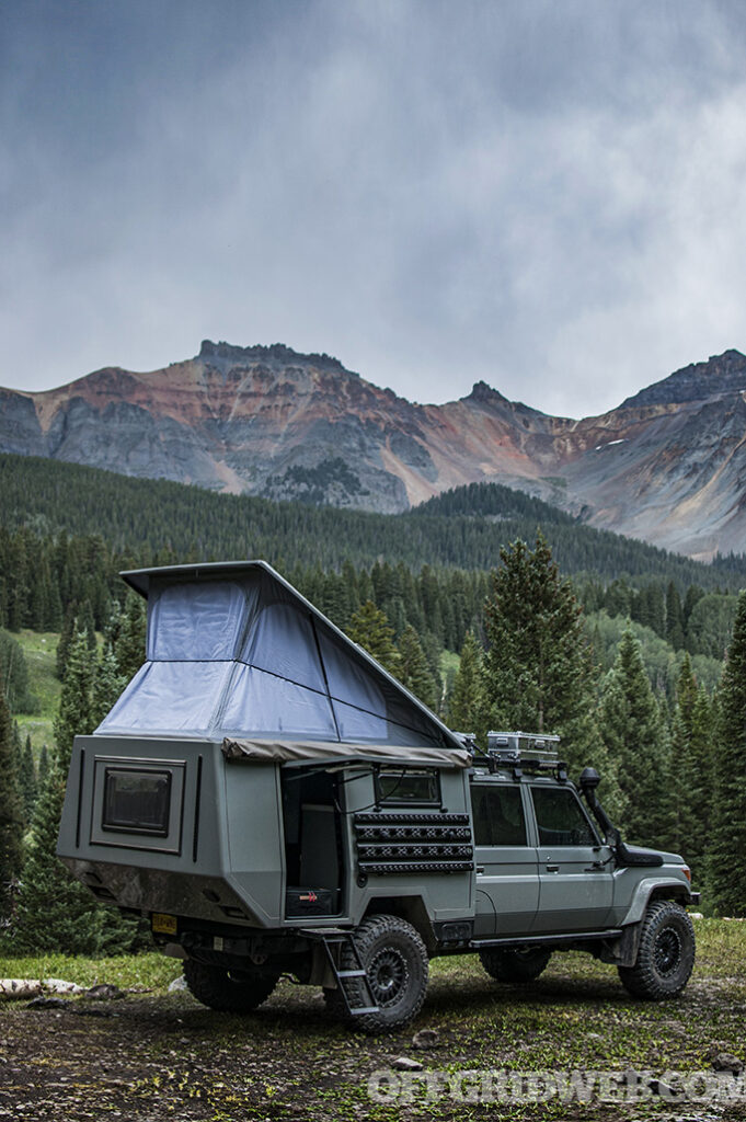 Photo of a Toyota with the canopy of a bed camper extended.