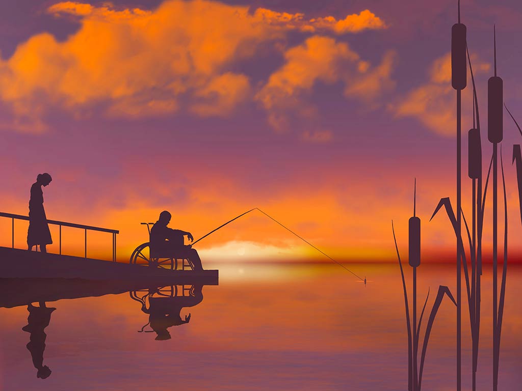 A view across the water from some reeds towards a man fishing from a wheelchair in Indiana at sunset, with a woman stood behind him, with the sun setting in the distance and creating a bright orange hue across the entire image