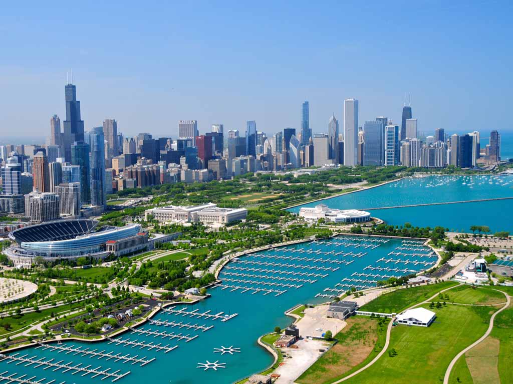 An aerial view of the city of Chicago, its skyline, as well as Lake Michigan and its many shoreline docks. The lake is one of the best fishing destinations you can visit in the US during spring.