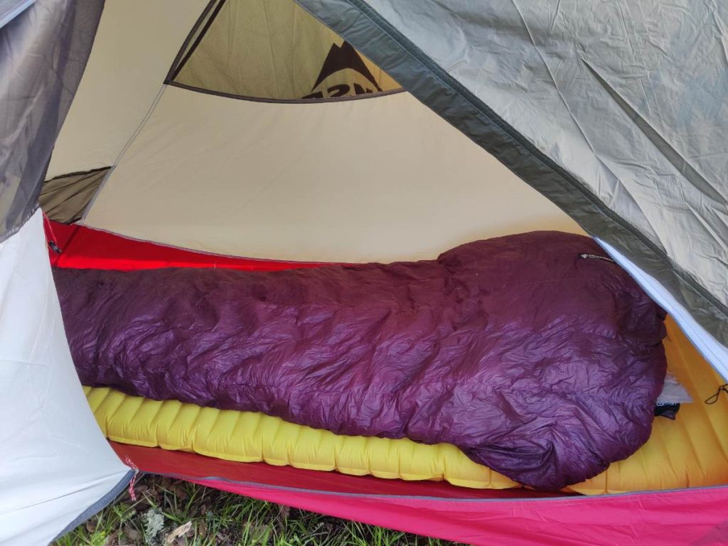 Looking through the door of the Hubba Hubba tent to see a sleeping quilt and inflatable pad