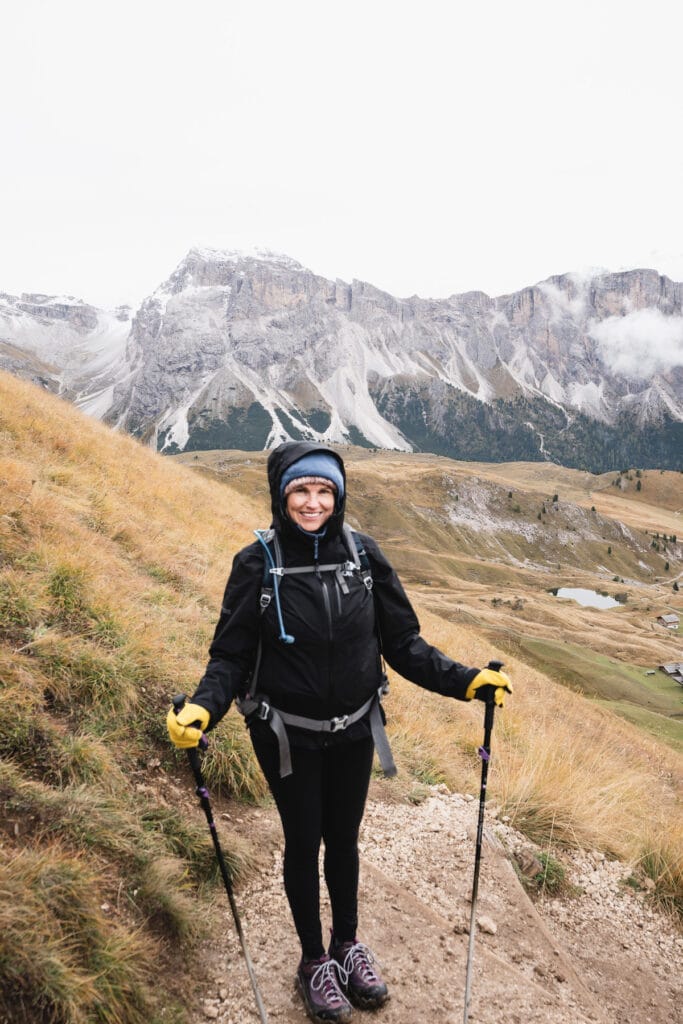 Kristen Bor wearing the Outdoor Research Aspire II Rain Jacket while hiking in the Italian Dolomites