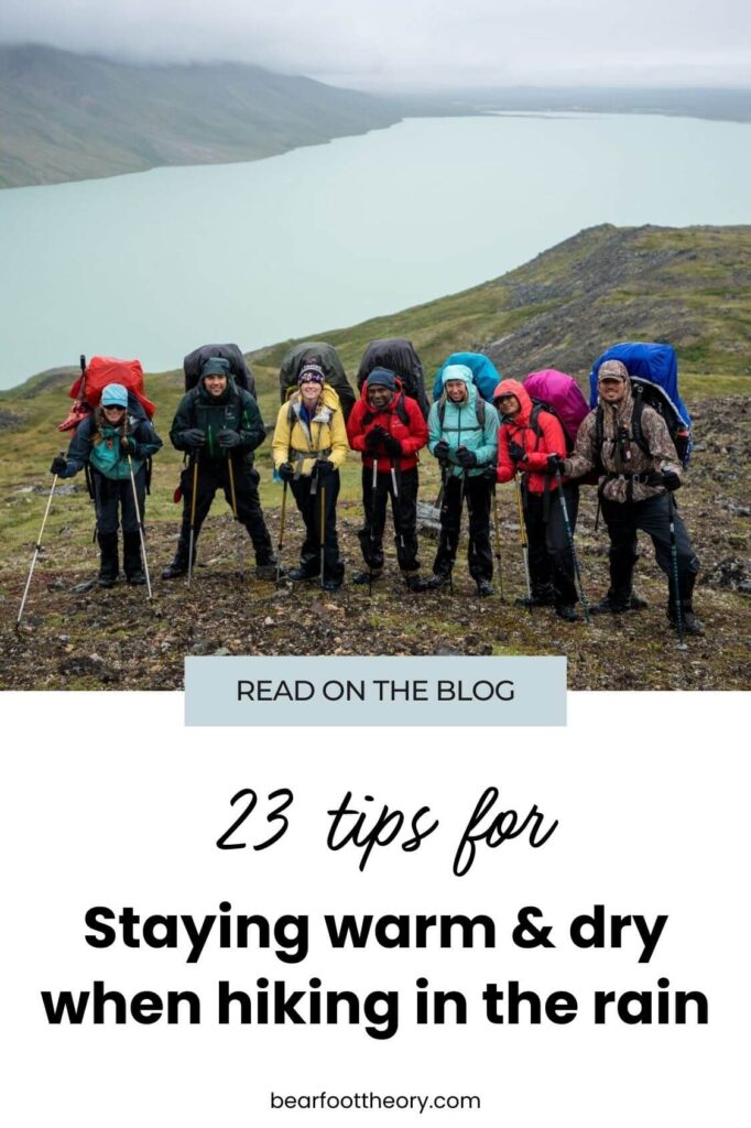 Pinnable image of group of backpackers dressed in rain gear. Text reads "23 tips for staying warm and dry when hiking in the rain"