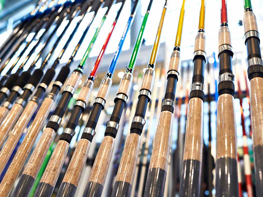 A closeup of different colored blanks of fishing rods in a store