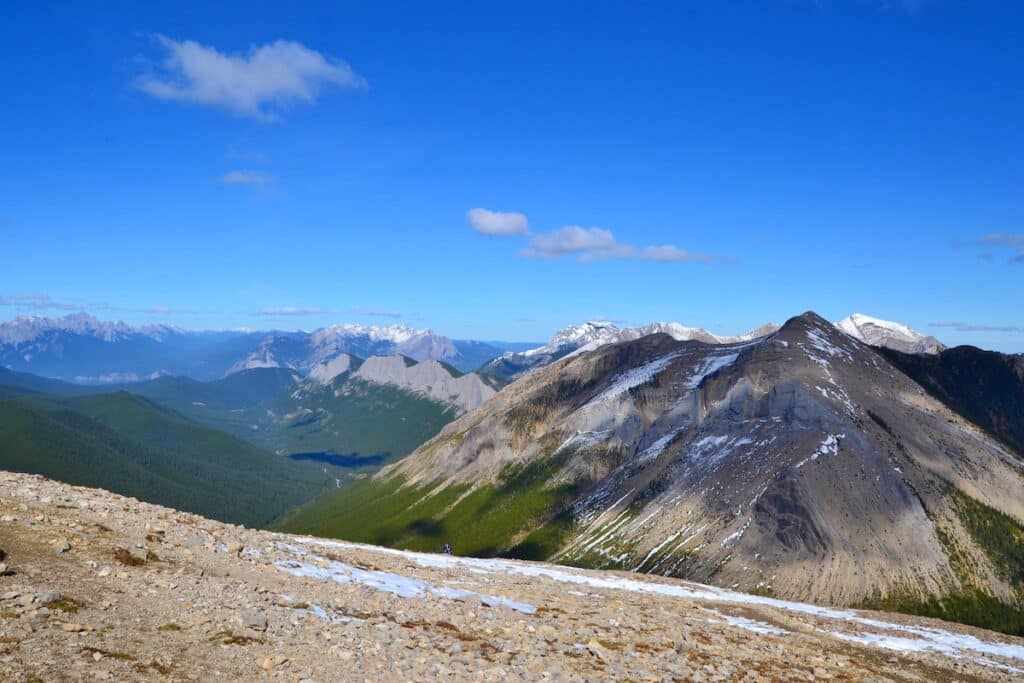 Sulphur skyline trail. Beautiful high mountains covered with snow, green forrest, white clouds, blue sky. National Park Jasper, Canada.