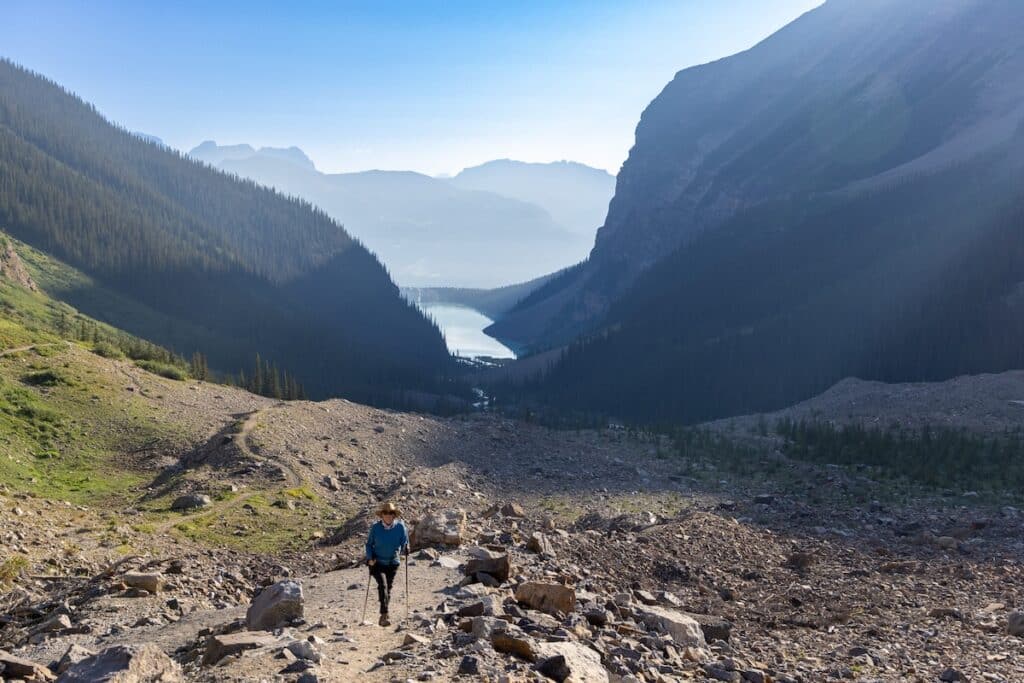 Woman hiking up Plain of Six Glaciers trail in Banff National Park