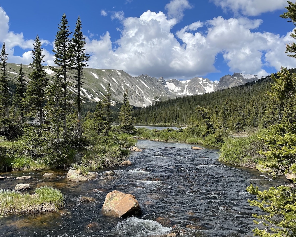 Water crossing with a mountain and trees on the trail of Lake Isabelle in Colorado