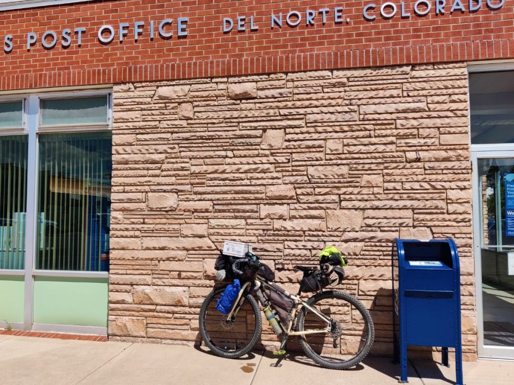 Bikepacking bike parked in front of a post office