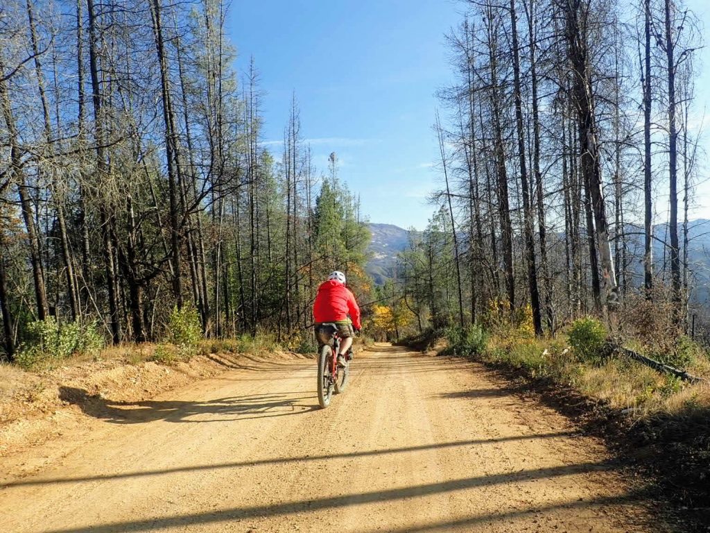 Bikepacker on dirt road in Mendocino National Forest