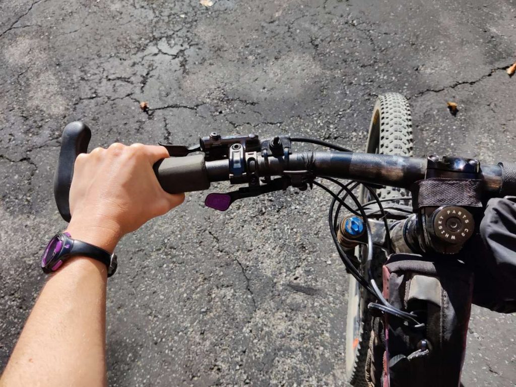 Close up of hand on grip of mountain bike handlebar