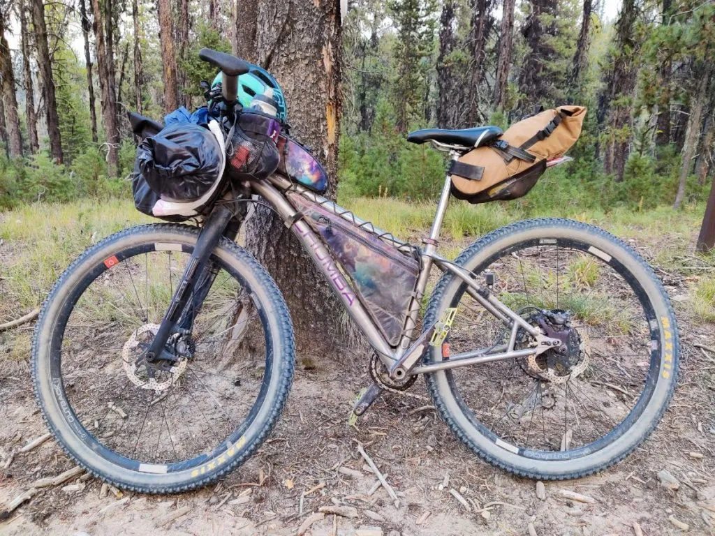 Rigid mountain bike with flat bars loaded with bikepacking gear