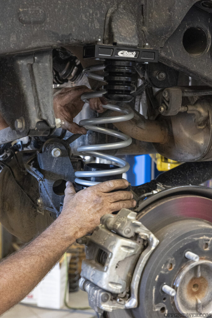 A piece of suspension being installed on a toyota 4runner.