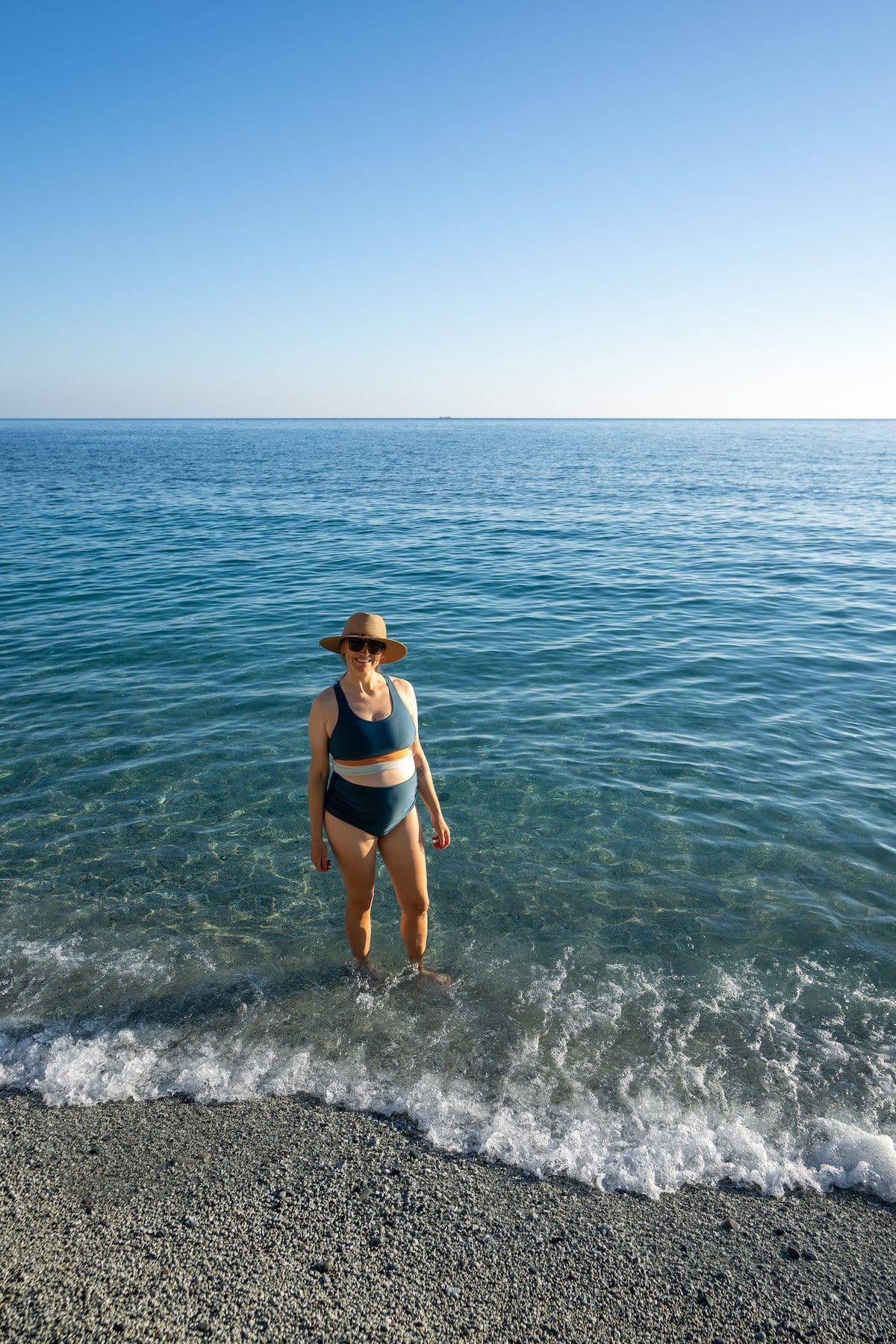 Kristen Bor wearing the Nani Swimwear Bikini top and ruched bottoms in the sea in Italy
