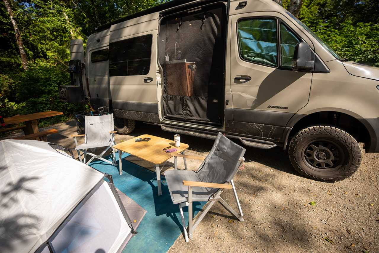 Two Dometic GO Compact Camping Chairs set up at camp, alongside a van and table in British Columbia