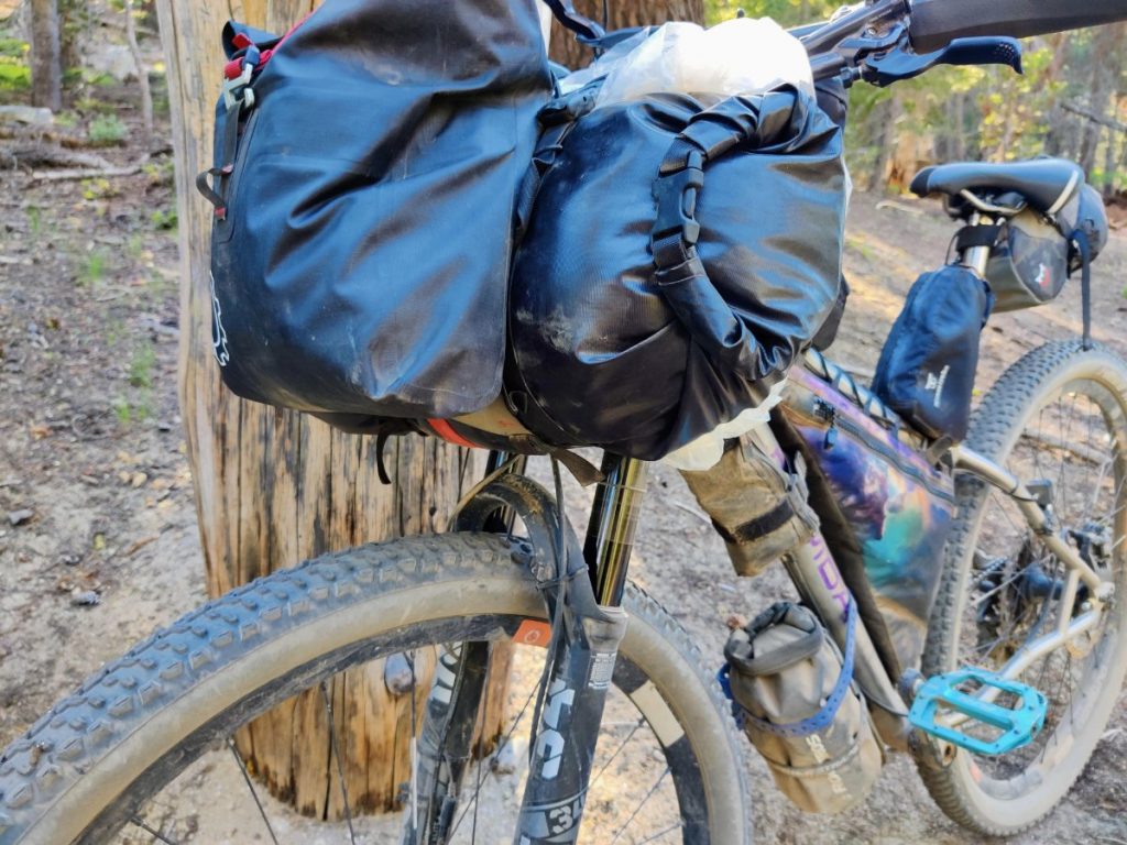 Handlebar bag and pouch on bikepacking bike with suspension fork