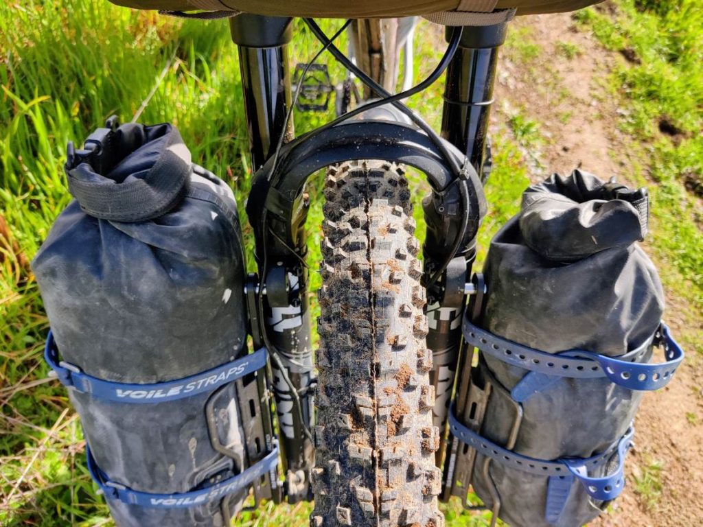 Suspension fork with Axle Pack and cargo cages holding dry bags for bikepacking