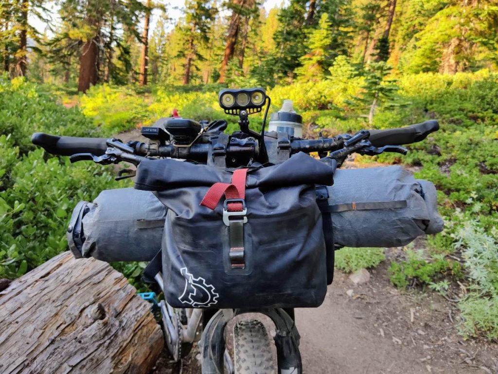 Front view of hardtail bikepacking bike loaded with handlebar bag and pouch