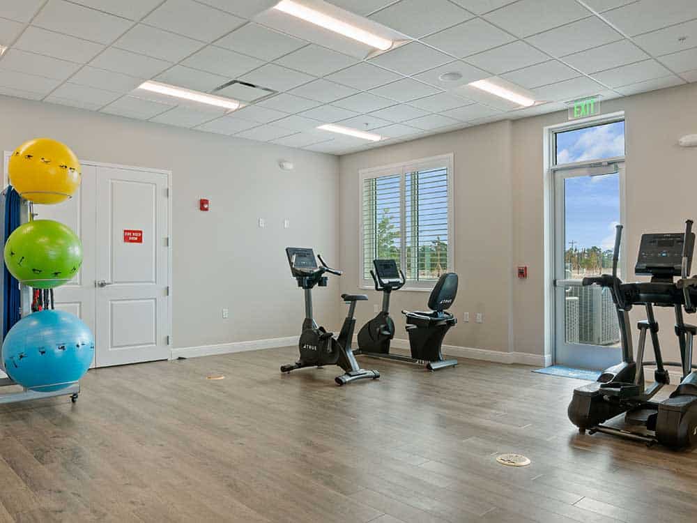 Exercise equipment in a roomy space with exercise balls.