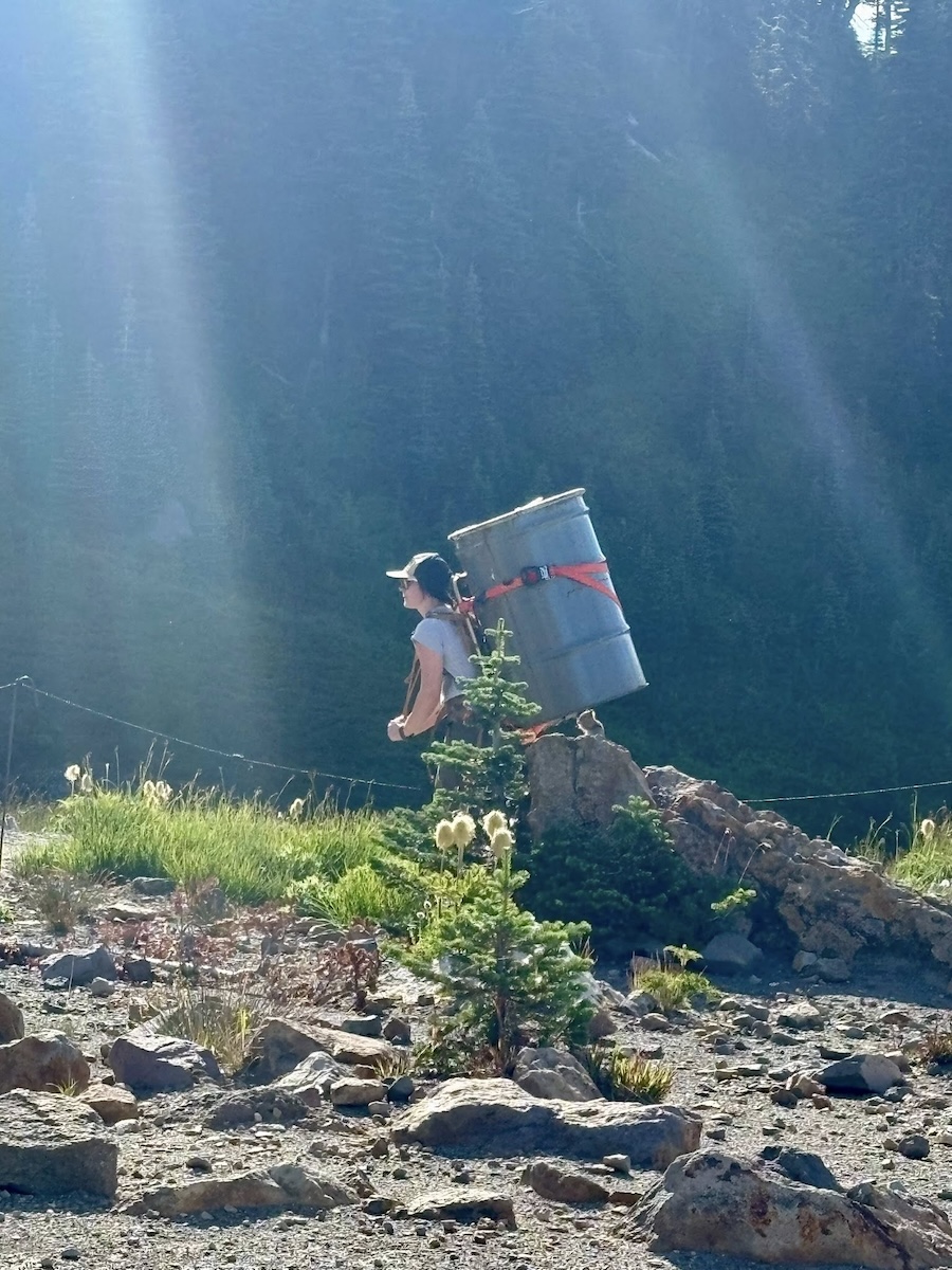 woman hiking with barrel Rainier